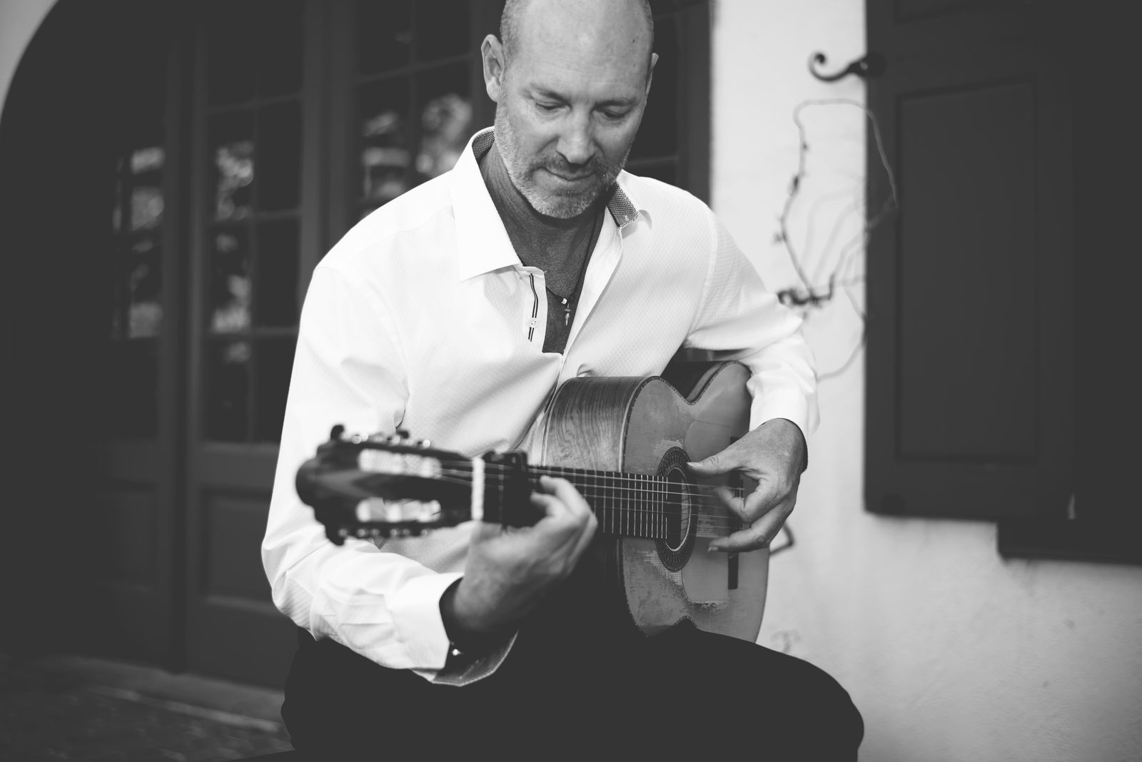 Dirty Flamenco in a stone courtyard, in black and white.
