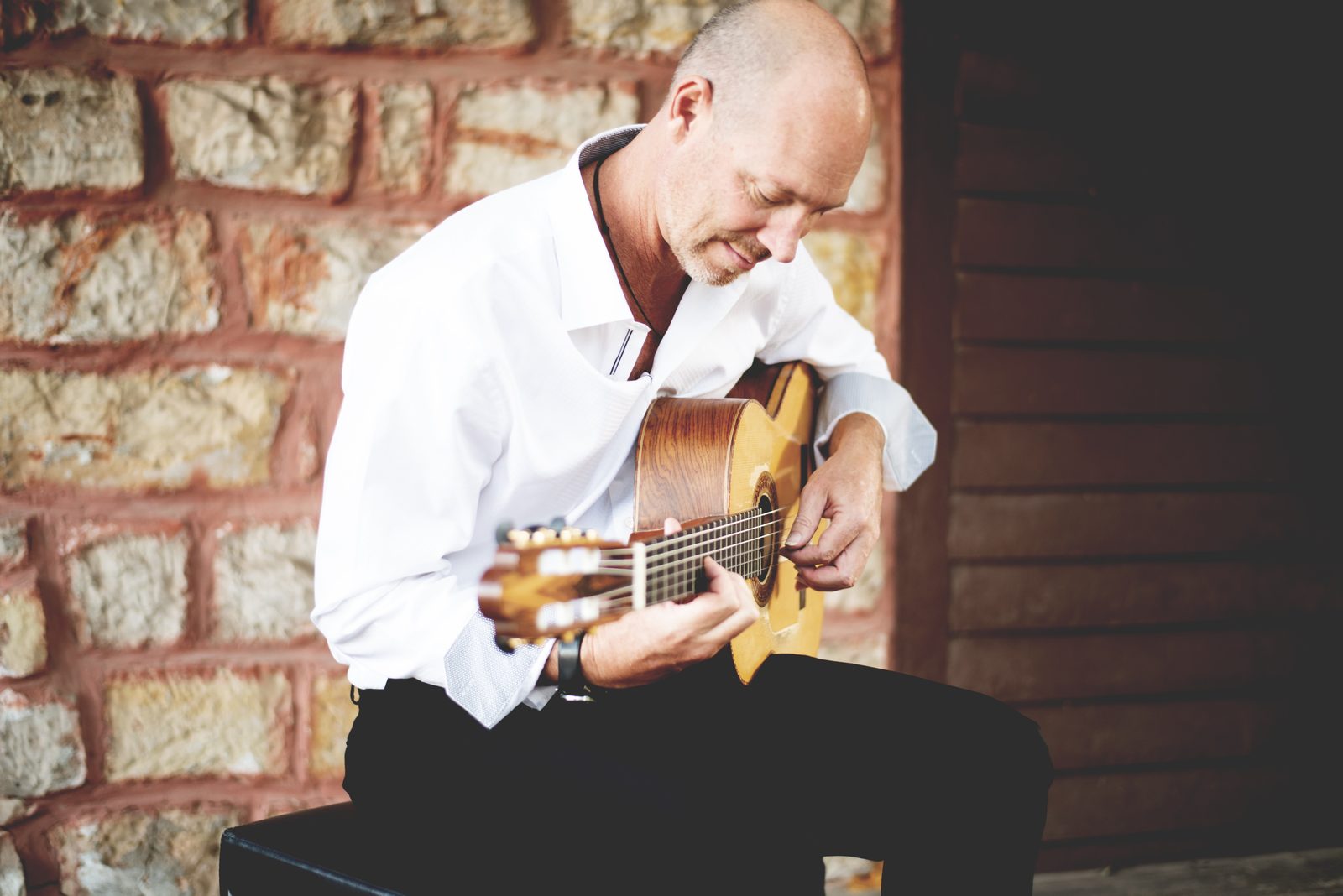 Gary Meyers playing against a stone wall.