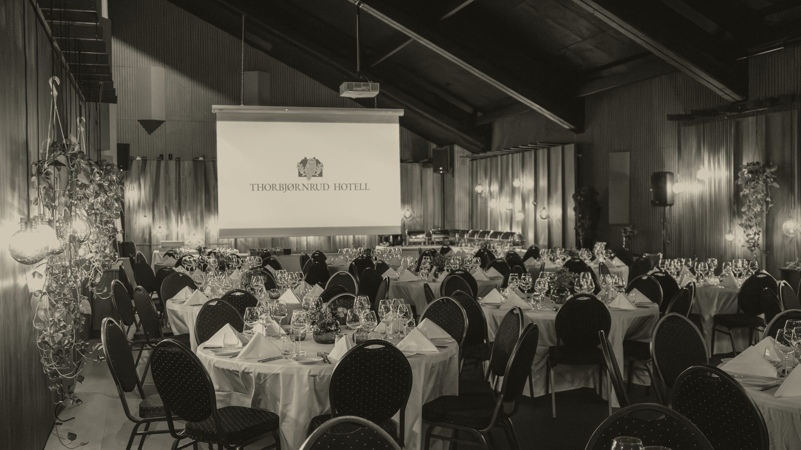 An empty banquet hall set for dinner.